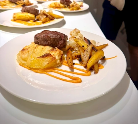 Onboard chef plating a steak dinner